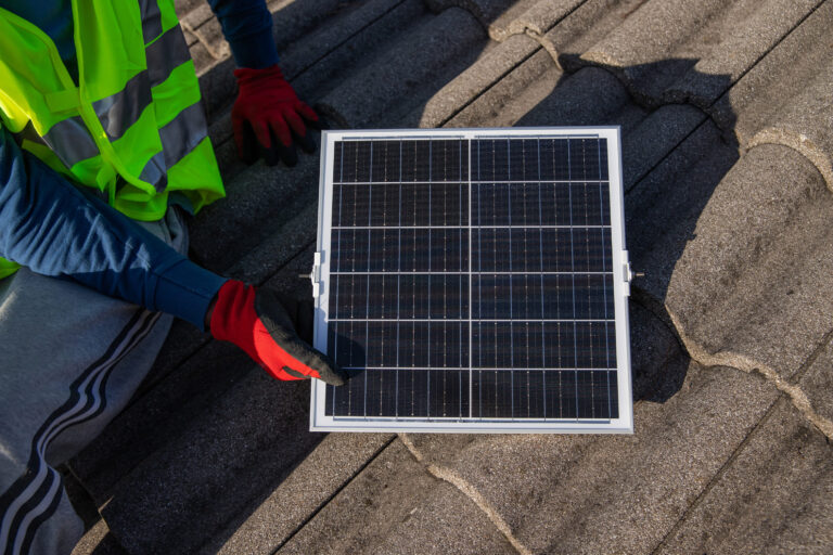 a-technician-installs-a-photovoltaic-solar-panel-o-2023-02-14-18-12-51-utc